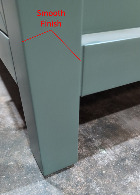 Green bathroom vanity leg with a smooth, even 7-coat polyurethane finish